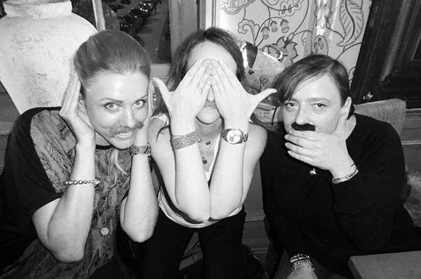 Three women with fake moustaches doing 3 Wise Monkeys
