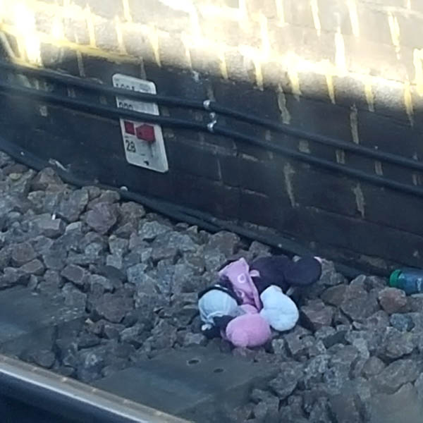 Face down cuddly toy by the railway track