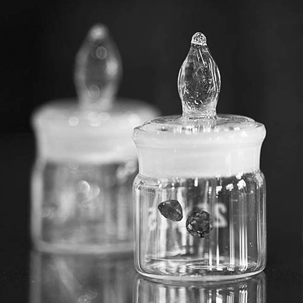 Gemstones displayed floating in little glass pots