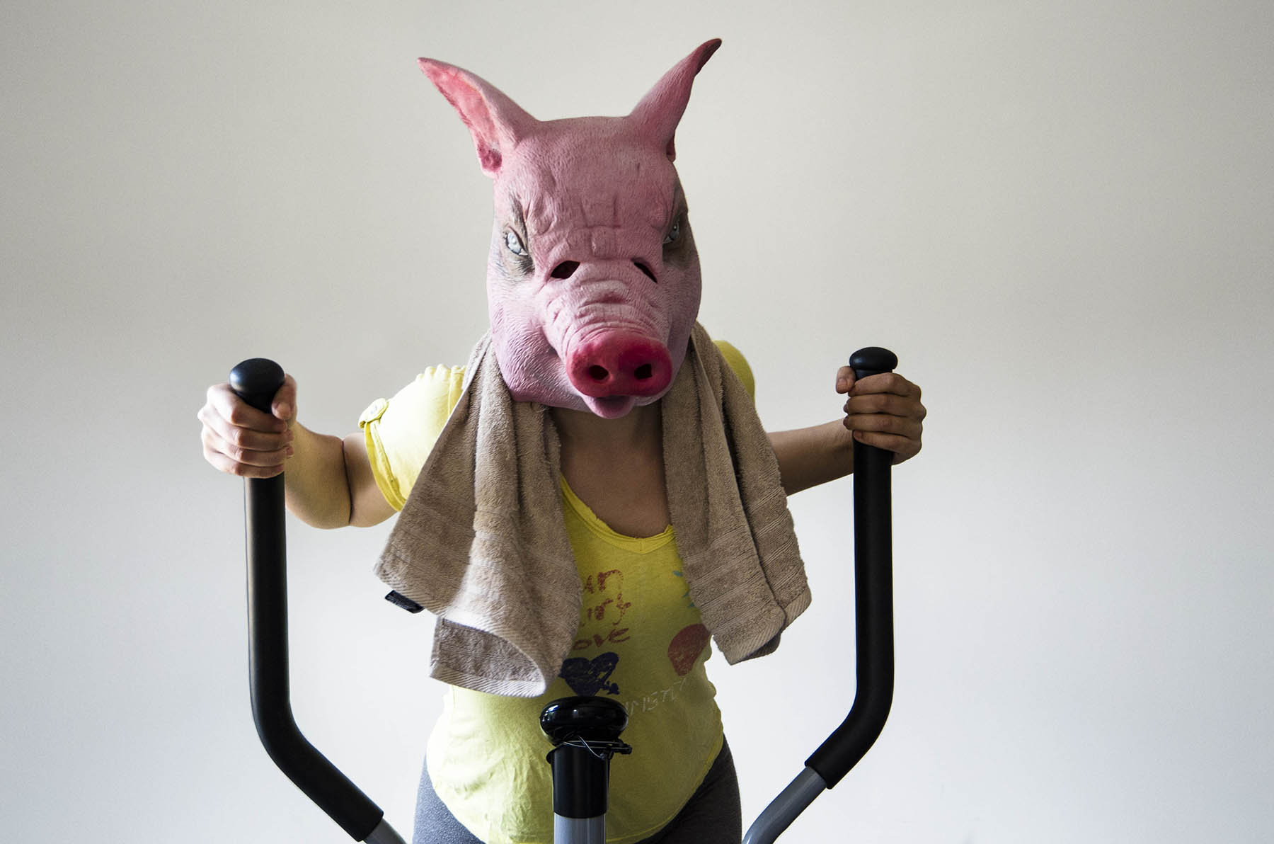 Beast - person wearing pig mask on cross trainer