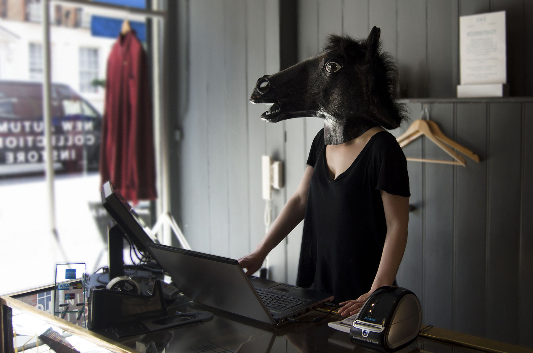 Beast - person wearing horse mask at clothing store cashdesk