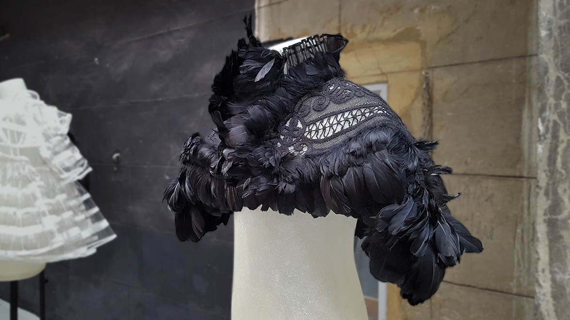 Burberry cape made from black feathers and openwork swirls