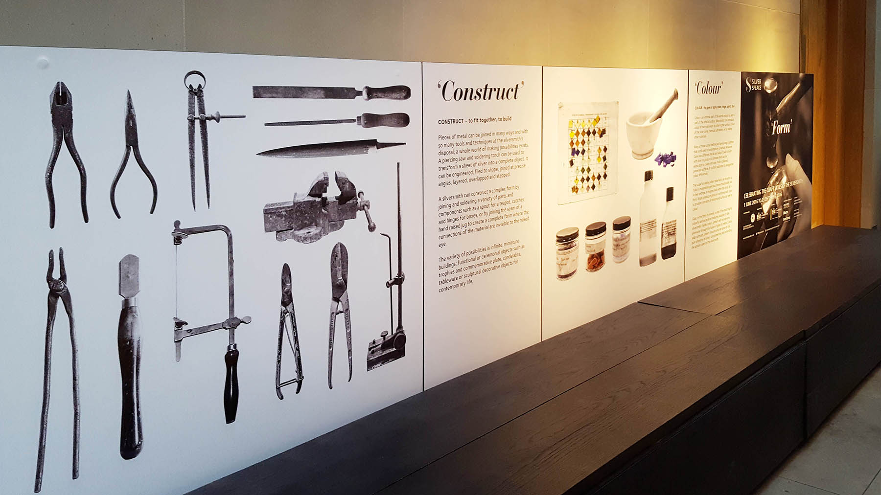 Silver Speaks Form Exhibition wall vinyls showing images of silversmithing tools and information