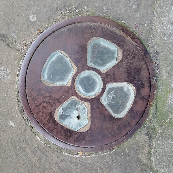 Manhole Cover, London - Cast iron with glass insert propeller pattern