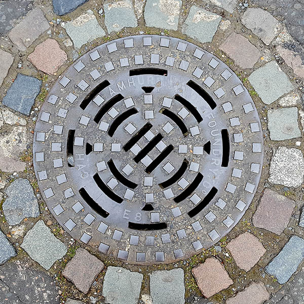 Manhole Cover, London - Cast iron raised squares and openwork grid pattern