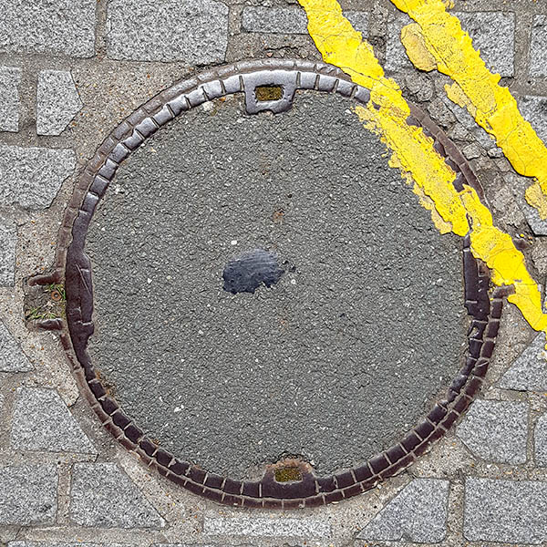 Manhole Cover, London - Cast iron raised squares on rim with concrete centre