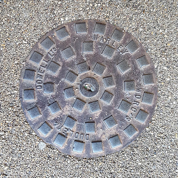 Manhole Cover, London - Cast iron raised squares inscribed with Dudley & Dowell Ltd Warley Worc's