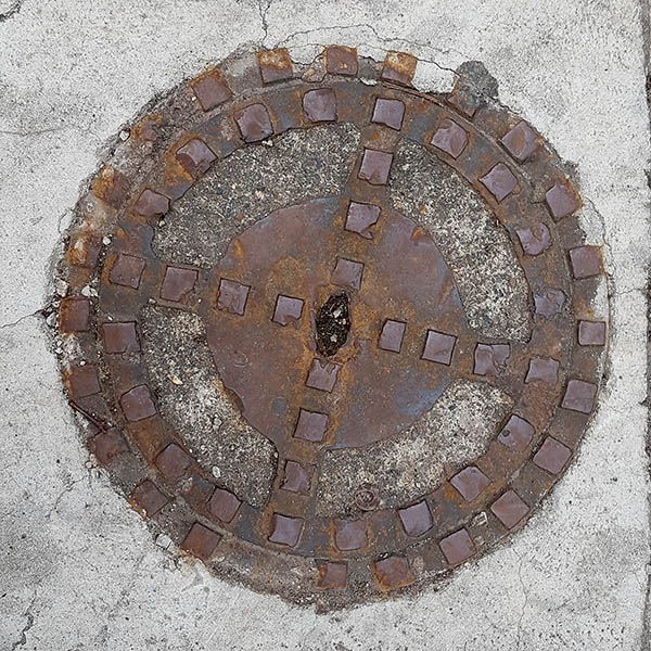 Manhole Cover, London - Cast iron raised squares and concrete inserts
