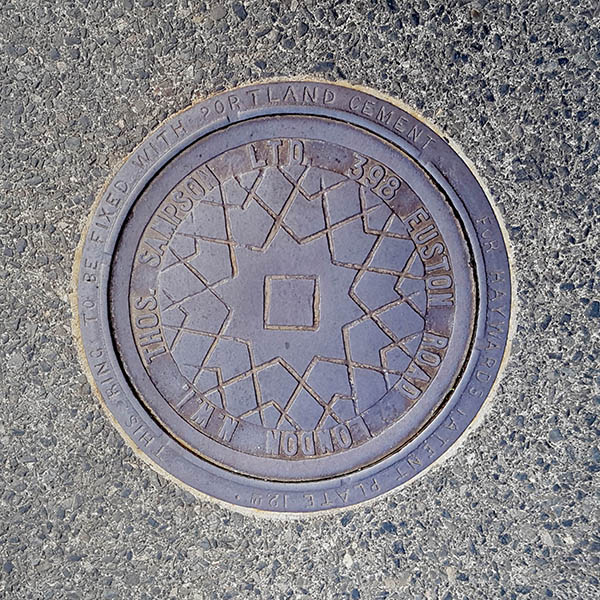 Manhole Cover, London - Cast iron with star centre and surrounding text