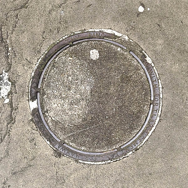 Manhole Cover, London - Cast iron surround with concrete centre