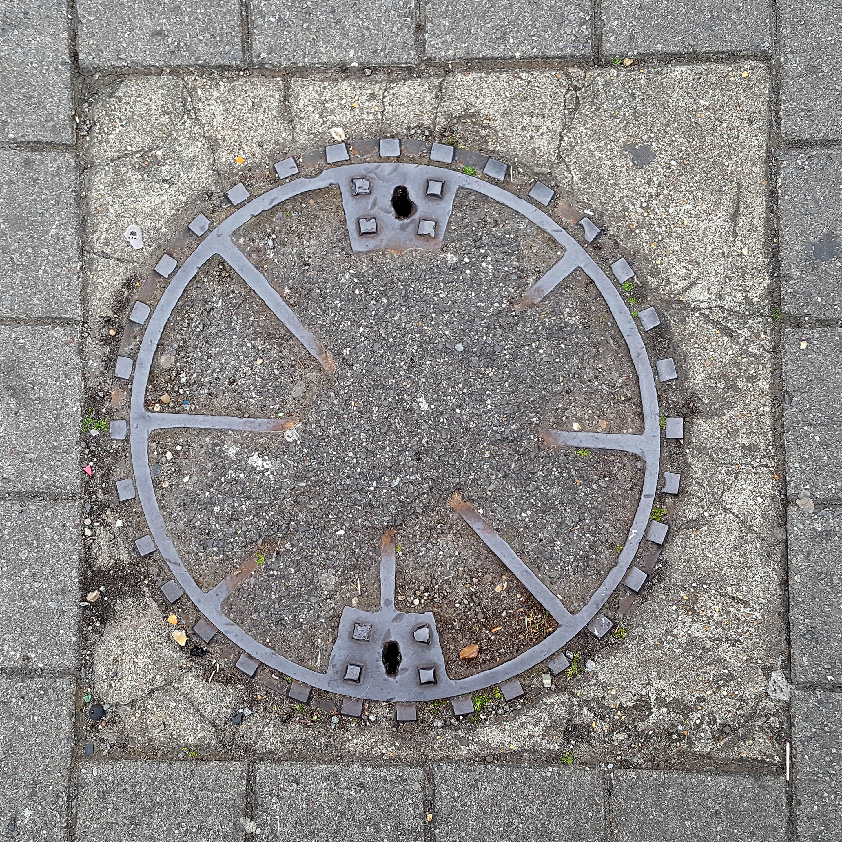 Manhole Cover, London - Cast iron surround with concrete centre divided into eight segments
