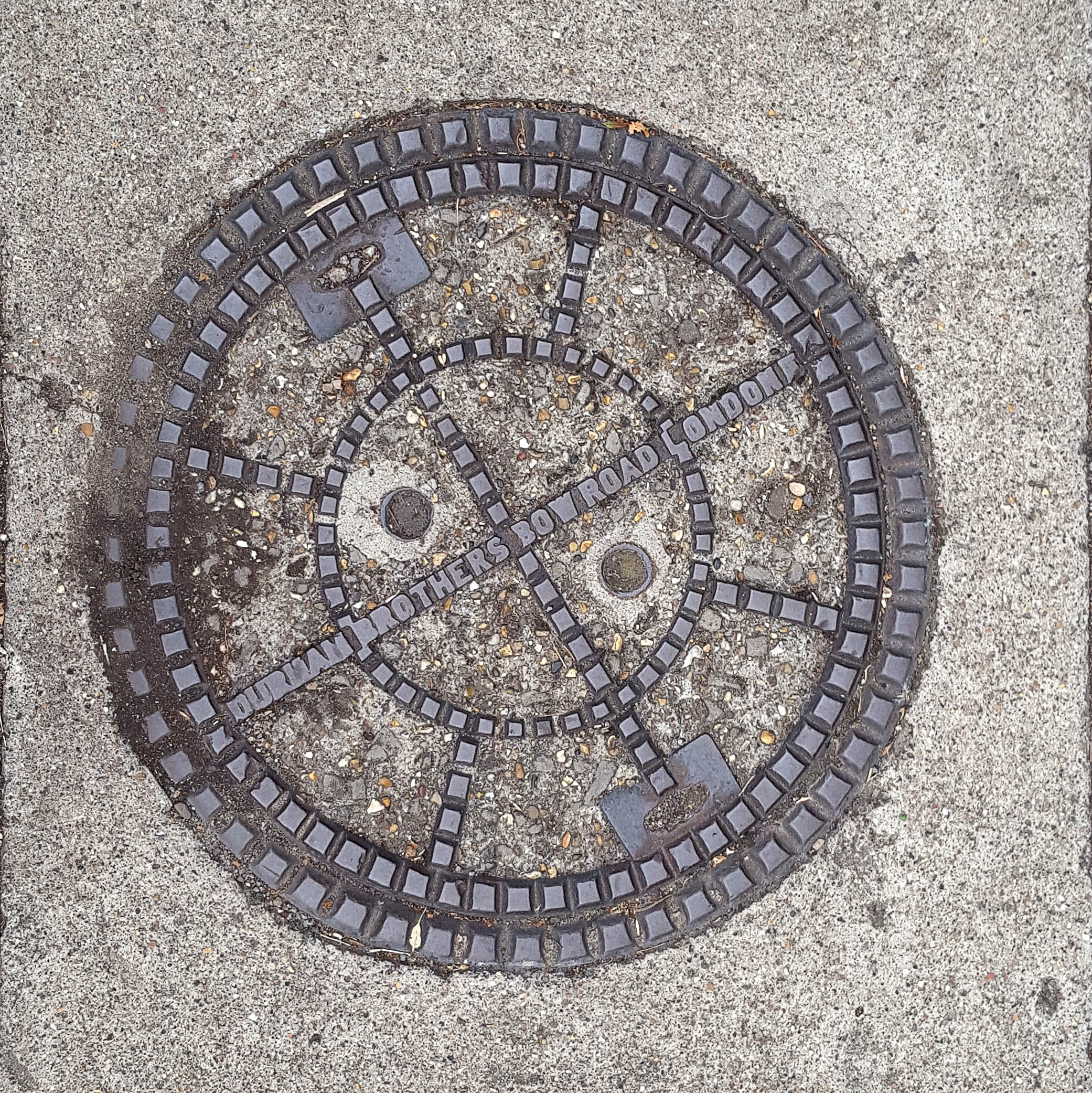 Manhole Cover, London - Cast iron surround with concrete centre divided into eight segments - Inscribed with Durman Brothers Bow Road London