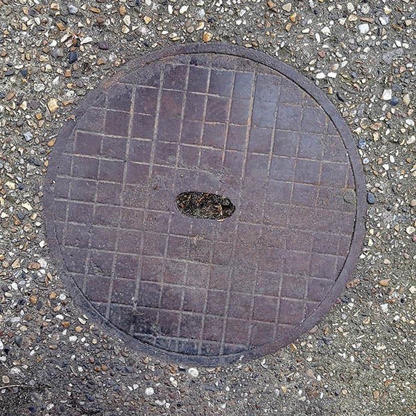 Manhole Cover, London - Cast iron with grid pattern and oval cut out