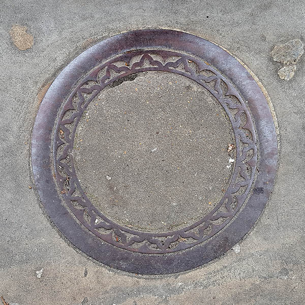 Manhole Cover, London - Decorative cast iron surround with concrete centre