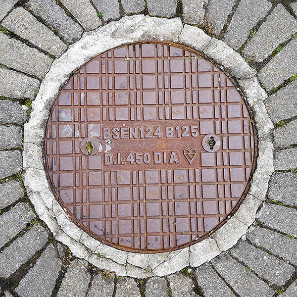 Manhole Cover, Essex - Cast iron grid pattern, inscribed with BSEN124 B125 D.I.450 DIA