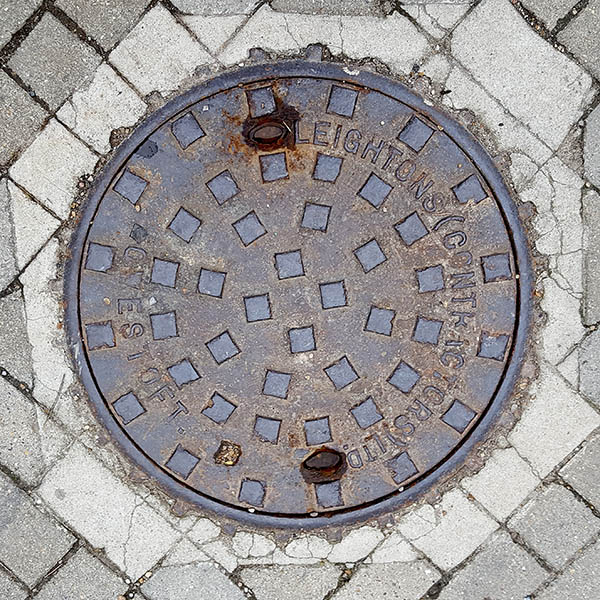 Manhole Cover, Essex - Cast iron with raised square pattern, inscribed with LEIGHTONS (CONTRACTORS) LTD OWESTOFT