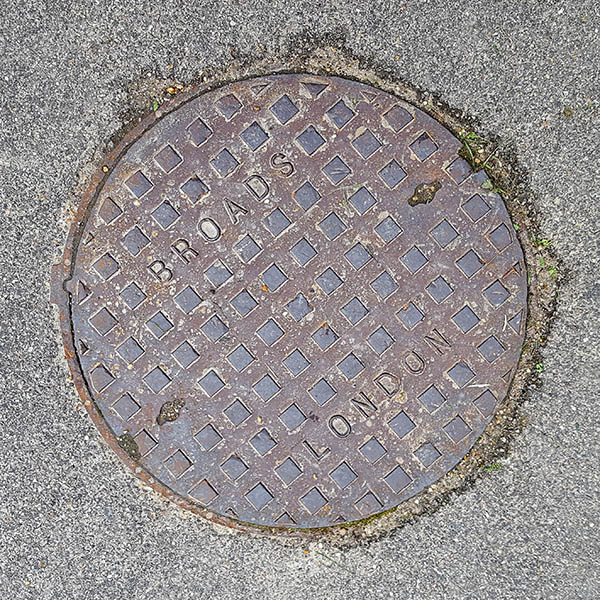 Manhole Cover, Essex - Cast iron with raised square pattern, inscribed with BROADS LONDON