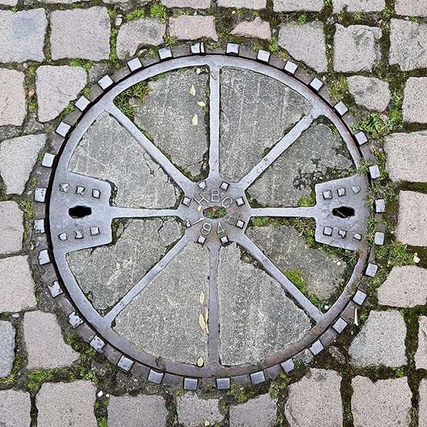 Manhole Cover, London - Cast iron surround with eight segments of concrete