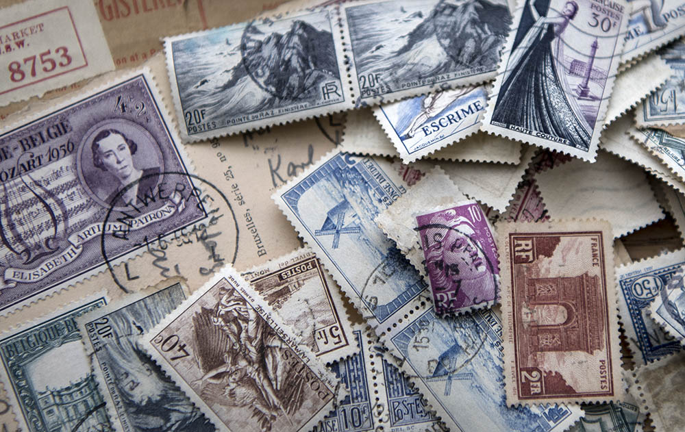 Vintaged postage stamps scattered