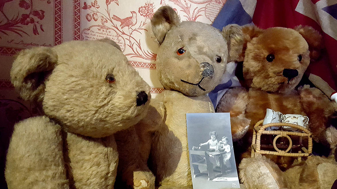 3 vintage teddy bears displayed in Pollocks Toy Museum 