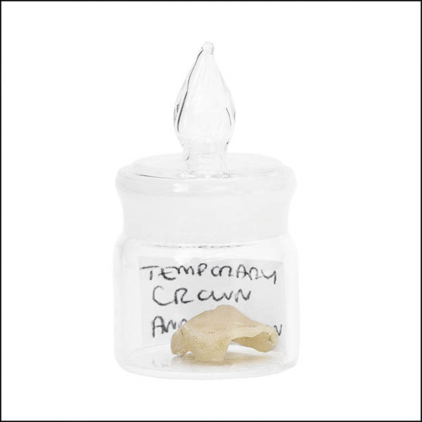 Temporary crown in glass pot - part of tooth collection