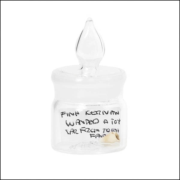 Baby tooth in glass pot - part of tooth collection