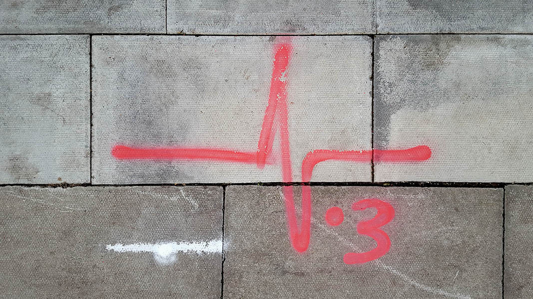 Pavement markings - spray painted squiggles on paving stones - Red heartbean and .3