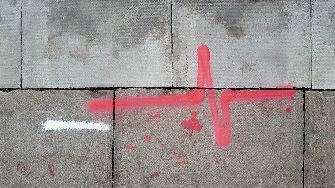 Pavement markings - spray painted squiggles on paving stones - Red heartbeat