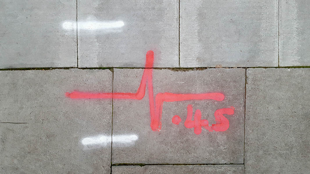 Pavement markings - spray painted squiggles on paving stones - Red heartbeat and 4.5