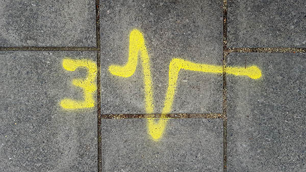 Pavement markings - spray painted squiggles on paving stones - Yellow 3 and heartbeat line
