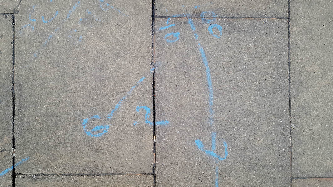 Pavement markings - spray painted squiggles on paving stones - Blue writing and lines