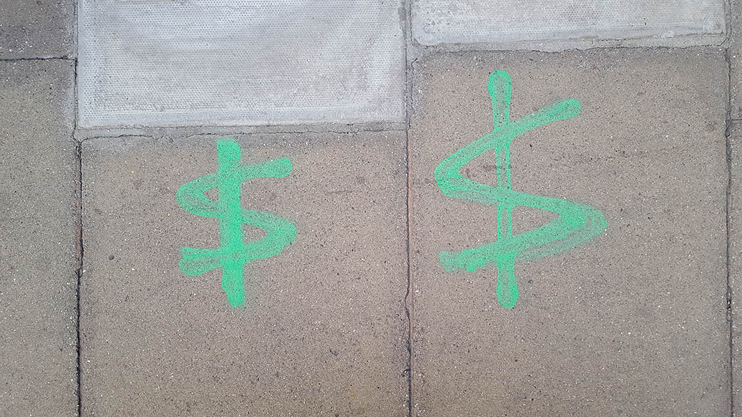 Pavement markings - spray painted squiggles on paving stones - Two green crossed through zig zags