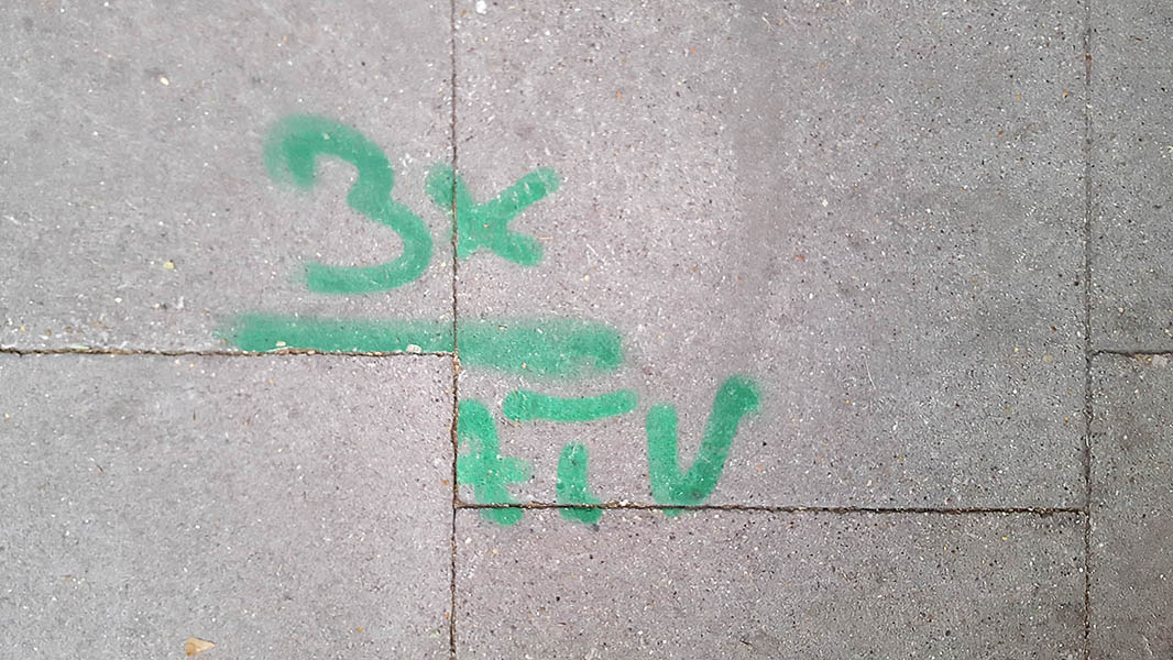 Pavement markings - spray painted squiggles on paving stones - Green 3 x 4TV