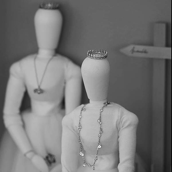Artist mannequin wearing a wedding dress and a diamond ring as a crown