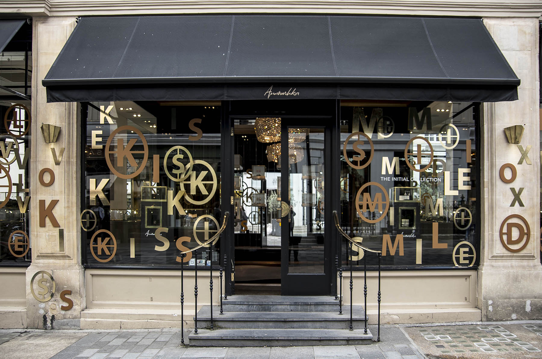 Annoushka Initials window display - gold and copper letters spelling Kiss and Smile