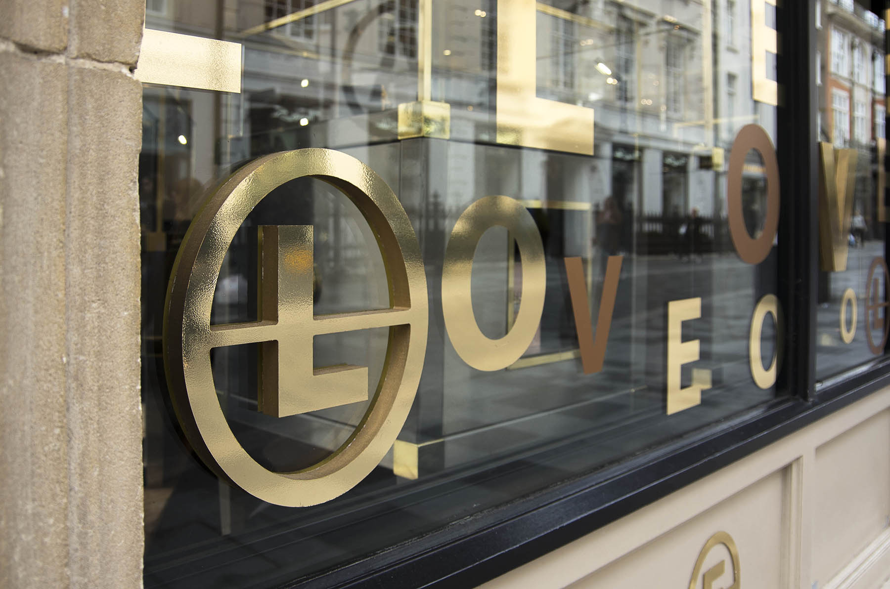 Annoushka Initials window display - gold and copper letters spelling Love